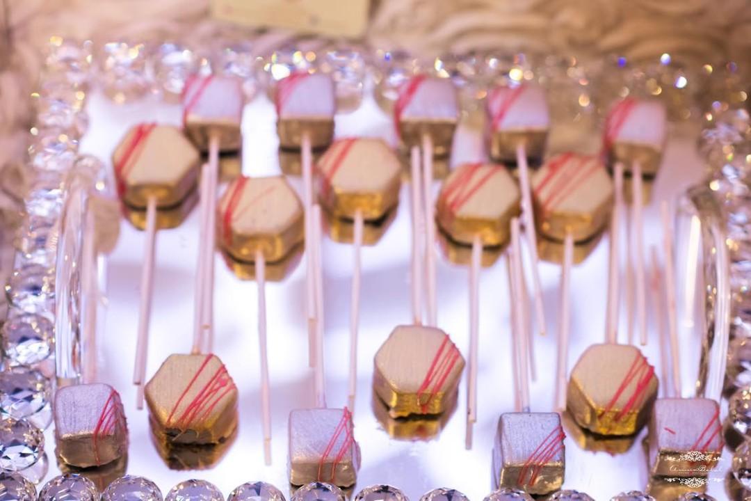 Gold and pink cake pops on a crystal tray