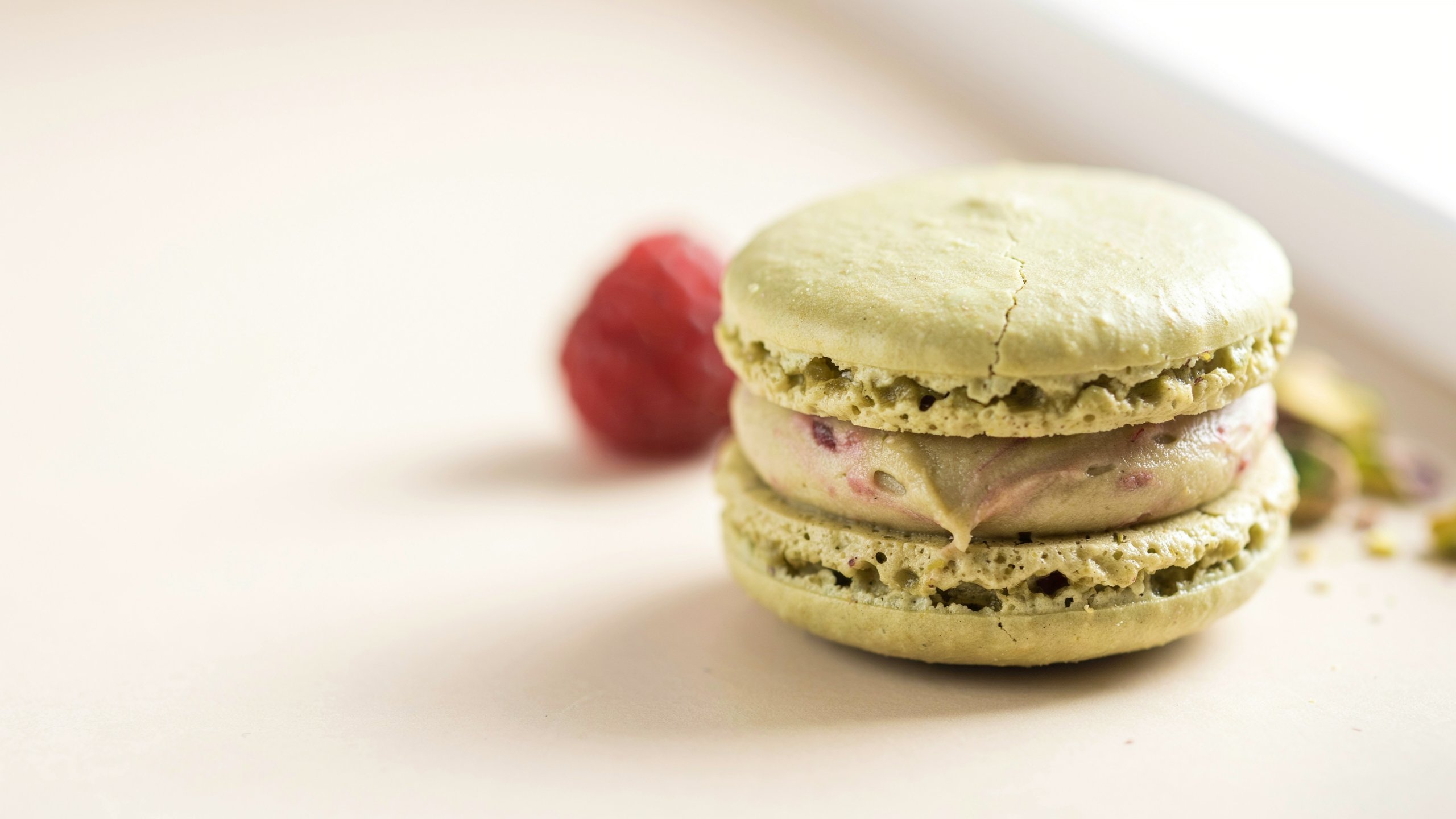 Pistachio and raspberry macaron, extreme close-up